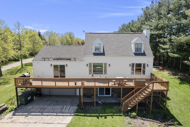 W6815 N Walworth Rd, Walworth, WI 53184 - back of house featuring a wooden deck, roof with shingles, an attached garage, and a lawn