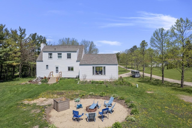 W6815 N Walworth Rd, Walworth, WI 53184 - back of property with a yard, an outdoor fire pit, and roof with shingles