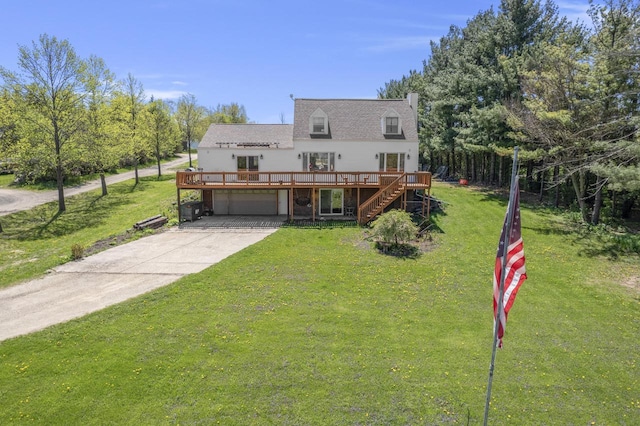 W6815 N Walworth Rd, Walworth, WI 53184 - view of front facade featuring a wooden deck, stairway, concrete driveway, a front yard, and an attached garage