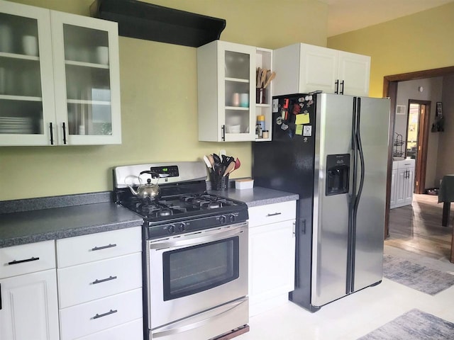 1425 Rogers St, Stevens Point, WI 54481 - kitchen with appliances with stainless steel finishes, glass insert cabinets, white cabinets, and dark countertops