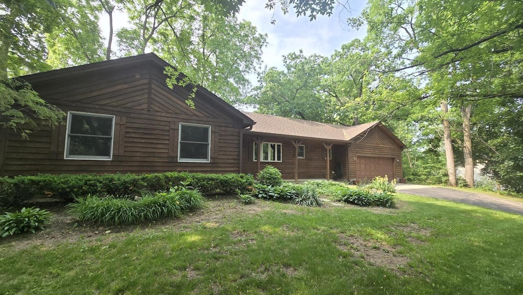 519 Bird Rd, Twin Lakes, WI 53181 - view of front facade featuring a garage, asphalt driveway, and a front yard