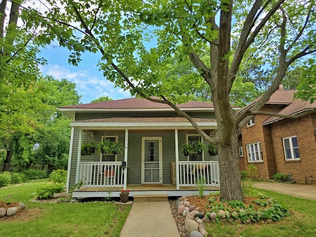 1716 Oak St, Stevens Point, WI 54481 - view of front of home with a porch and a front lawn