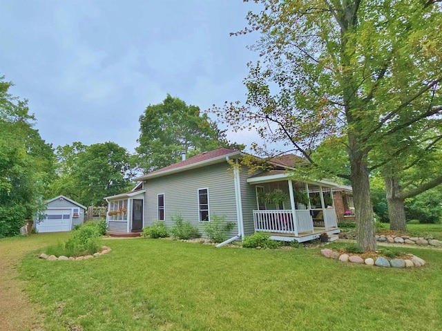 1716 Oak St, Stevens Point, WI 54481 - rear view of property featuring a yard, a porch, a garage, and an outdoor structure