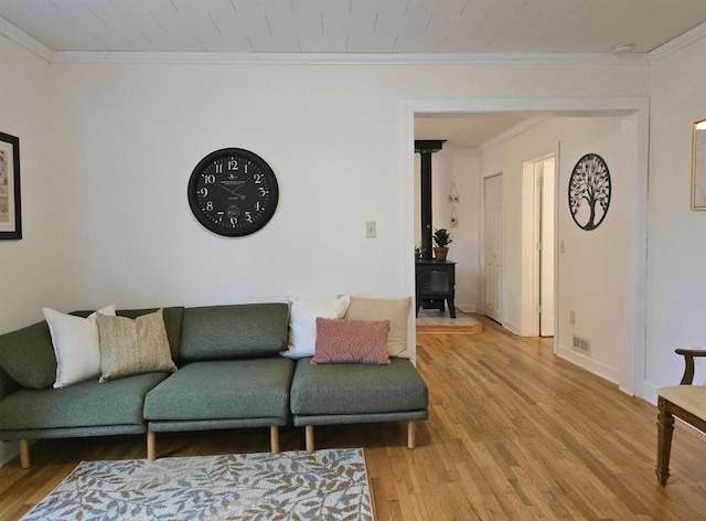 1716 Oak St, Stevens Point, WI 54481 - living room with a wood stove, crown molding, and light wood finished floors