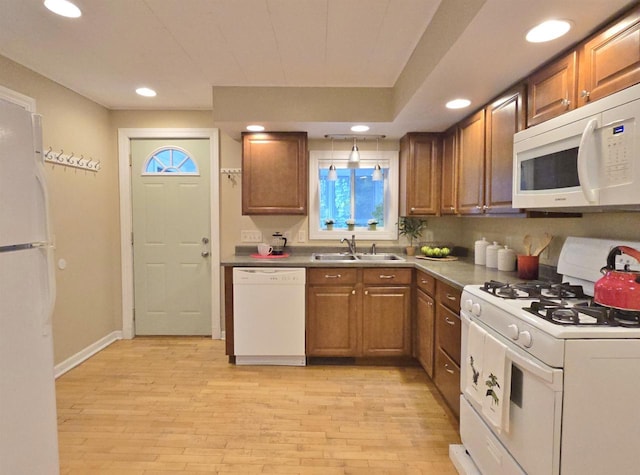 1716 Oak St, Stevens Point, WI 54481 - kitchen with white appliances, brown cabinetry, light wood-style floors, and recessed lighting
