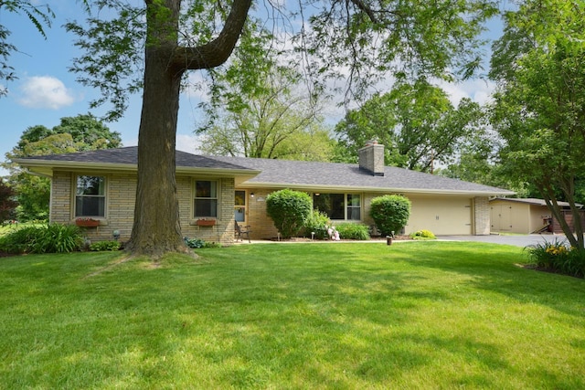 N68W15240 Prudence Dr, Menomonee Falls, WI 53051 - single story home featuring brick siding, a chimney, an attached garage, and a front lawn