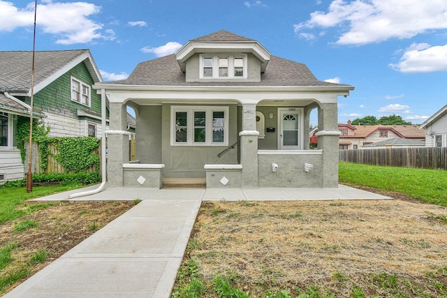 2863 N 38th St, Milwaukee, WI 53210 - bungalow-style home featuring stucco siding, a shingled roof, and covered porch