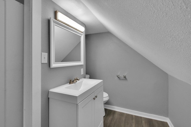 2863 N 38th St, Milwaukee, WI 53210 - bathroom with lofted ceiling, a textured ceiling, vanity, and wood finished floors