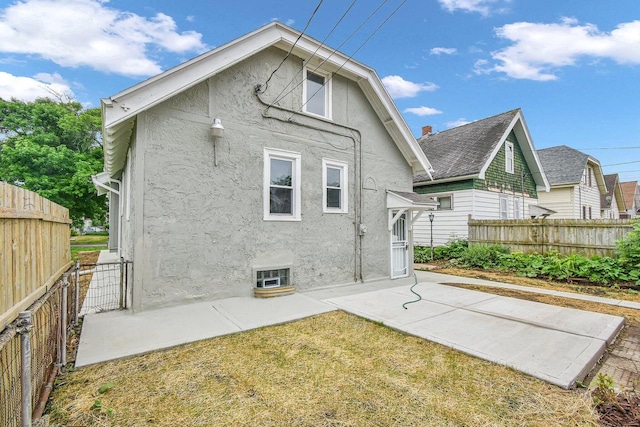 2863 N 38th St, Milwaukee, WI 53210 - rear view of house featuring stucco siding and a patio area