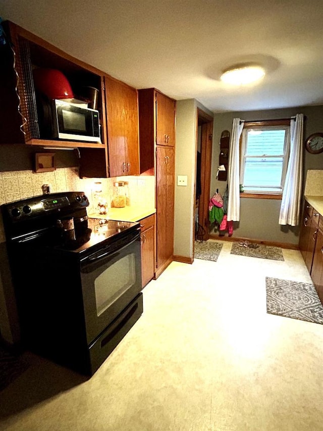 3151 Reddin Rd, Wisconsin Rapids, WI 54495 - kitchen with black appliances, brown cabinets, and light countertops