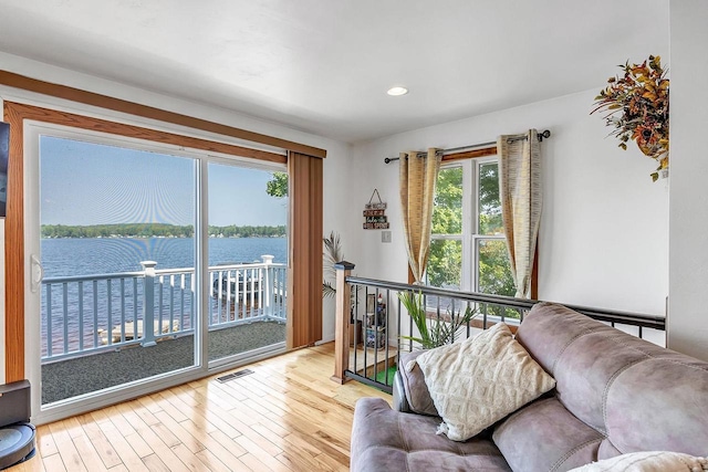 11975 E Anderson Lake Dr, Suring, WI 54174 - living area with wood finished floors, a water view, and recessed lighting