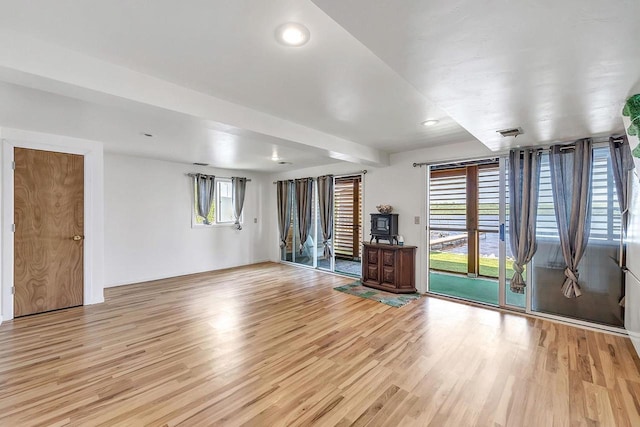 11975 E Anderson Lake Dr, Suring, WI 54174 - unfurnished living room with light wood-type flooring and recessed lighting