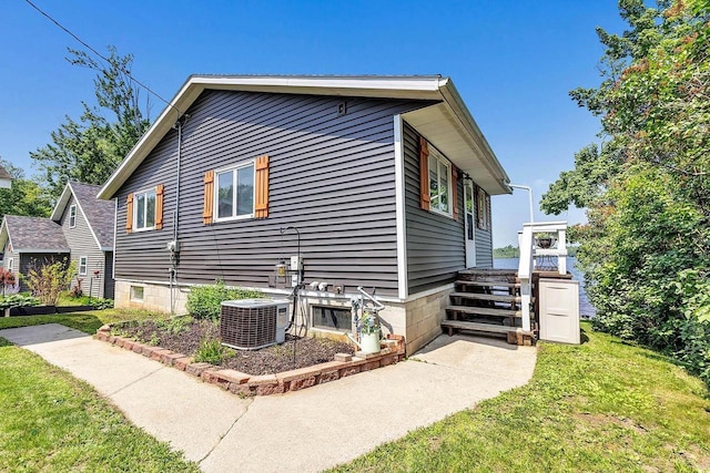 11975 E Anderson Lake Dr, Suring, WI 54174 - view of side of home with a cooling unit and a lawn
