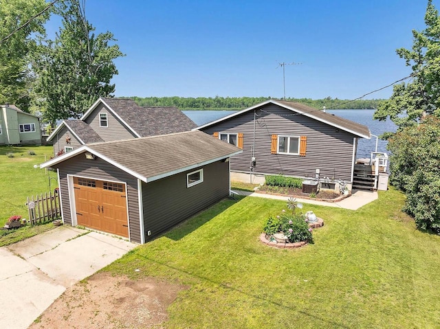 11975 E Anderson Lake Dr, Suring, WI 54174 - view of front of property featuring a front lawn, concrete driveway, a shingled roof, and an attached garage