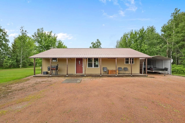 7454 State Highway 186, Arpin, WI 54410 - view of front of house with a detached carport, a front lawn, and a porch