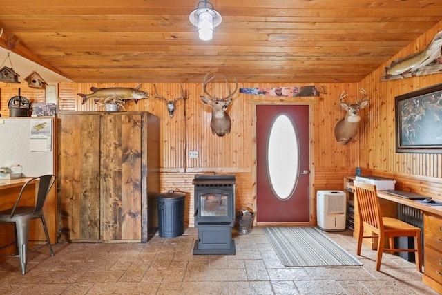 7454 State Highway 186, Arpin, WI 54410 - kitchen with wood ceiling, wooden walls, stone tile flooring, a wood stove, and vaulted ceiling