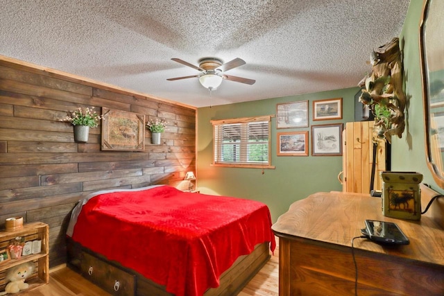 7454 State Highway 186, Arpin, WI 54410 - bedroom featuring a textured ceiling, wood finished floors, a ceiling fan, and wooden walls