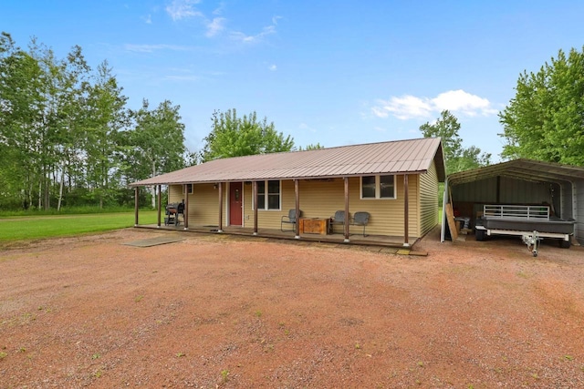 7454 State Highway 186, Arpin, WI 54410 - view of front of property with a detached carport, driveway, covered porch, and a metal roof