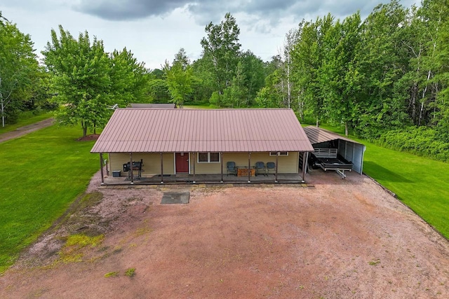 7454 State Highway 186, Arpin, WI 54410 - view of front of house featuring a porch, a carport, a front yard, and a metal roof