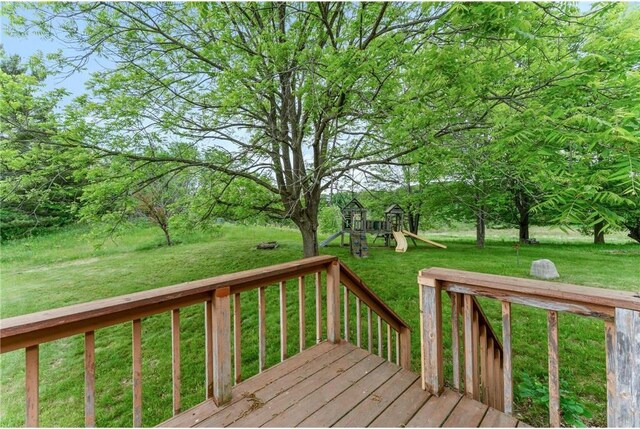 1231 135th St, Amery, WI 54005 - wooden terrace with a playground and a lawn