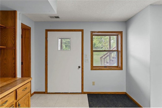 1231 135th St, Amery, WI 54005 - entrance foyer featuring a textured ceiling