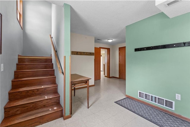1231 135th St, Amery, WI 54005 - stairs with tile patterned floors and a textured ceiling