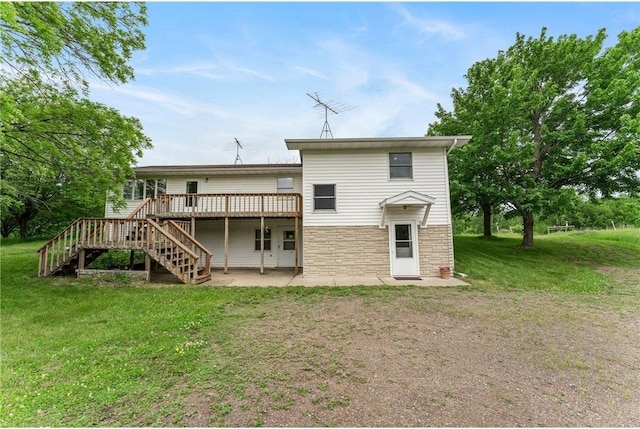 1231 135th St, Amery, WI 54005 - rear view of house featuring stairs, a wooden deck, a lawn, a patio area, and stone siding