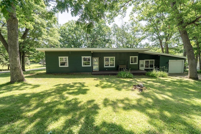 N3342 Hickory Rd, Lake Geneva, WI 53147 - view of front of property with a garage, a front yard, board and batten siding, and a deck