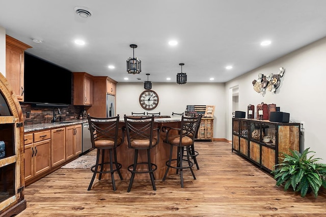 4140 N Prairie Rose Ln, Appleton, WI 54913 - indoor wet bar with stainless steel appliances, light wood-style flooring, recessed lighting, backsplash, and decorative light fixtures