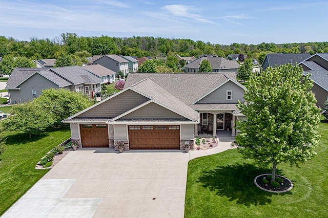 4140 N Prairie Rose Ln, Appleton, WI 54913 - view of front of house featuring driveway, a front yard, a garage, stone siding, and a residential view