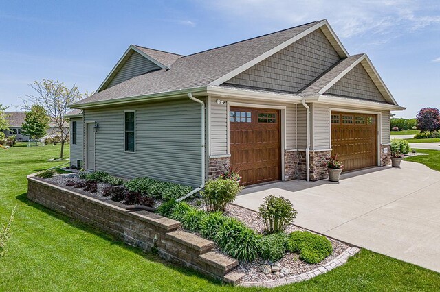 4140 N Prairie Rose Ln, Appleton, WI 54913 - view of side of property with roof with shingles, concrete driveway, and a yard