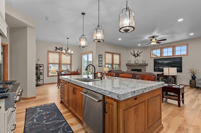 4140 N Prairie Rose Ln, Appleton, WI 54913 - kitchen with dishwasher, ceiling fan, brown cabinets, a fireplace, and stovetop