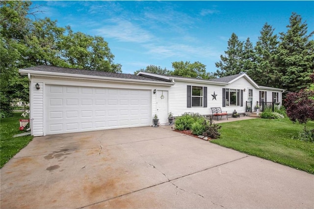 635 S 6th St, Barron, WI 54812 - view of front of house featuring concrete driveway, a front yard, and an attached garage