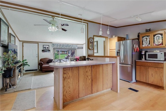 635 S 6th St, Barron, WI 54812 - kitchen featuring stainless steel refrigerator with ice dispenser, white microwave, track lighting, light countertops, and ceiling fan