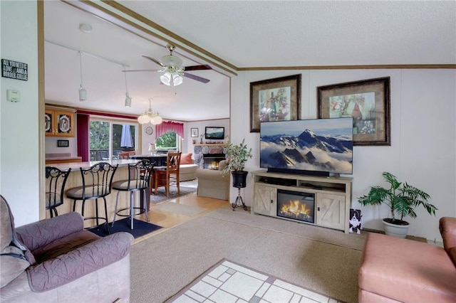 635 S 6th St, Barron, WI 54812 - living room with a glass covered fireplace, ceiling fan, and ornamental molding