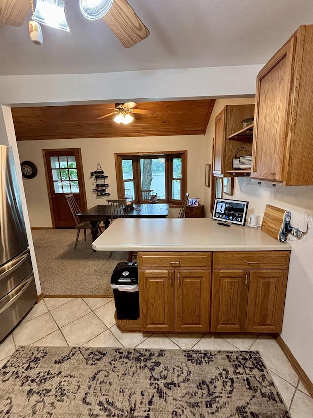 N3911 Lakeside Ln, Wautoma, WI 54982 - kitchen with open shelves, freestanding refrigerator, a peninsula, light tile patterned floors, and light countertops