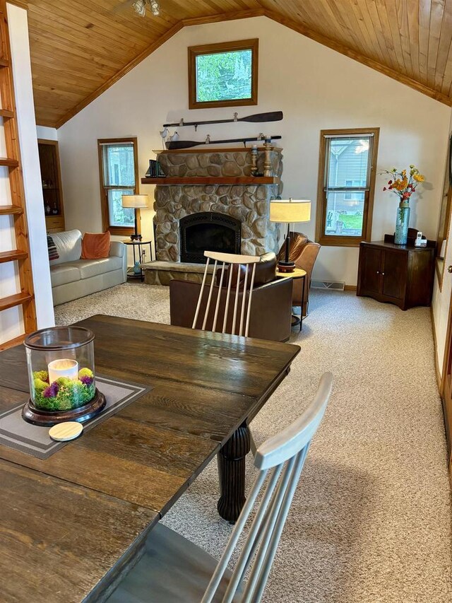 N3911 Lakeside Ln, Wautoma, WI 54982 - dining area featuring carpet flooring, wood ceiling, a fireplace, and vaulted ceiling