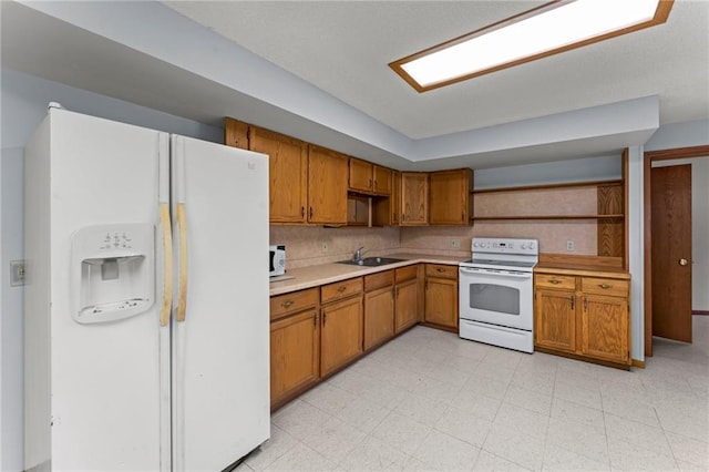 1231 135th St, Amery, WI 54001 - kitchen with white appliances, open shelves, light countertops, and brown cabinets
