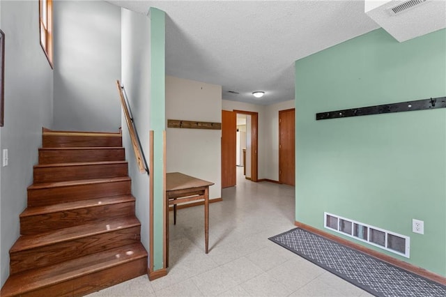1231 135th St, Amery, WI 54001 - stairway with tile patterned floors and a textured ceiling