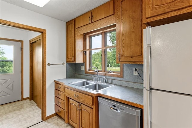 1231 135th St, Amery, WI 54001 - kitchen featuring freestanding refrigerator, dishwasher, brown cabinets, and light countertops
