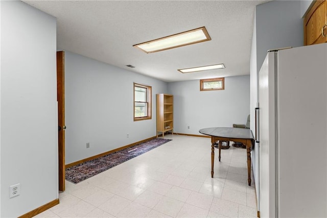 1231 135th St, Amery, WI 54001 - kitchen with freestanding refrigerator and a textured ceiling