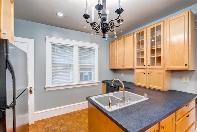 31 Elm St, Fort Atkinson, WI 53538 - kitchen featuring freestanding refrigerator, light brown cabinets, dark countertops, glass insert cabinets, and a chandelier
