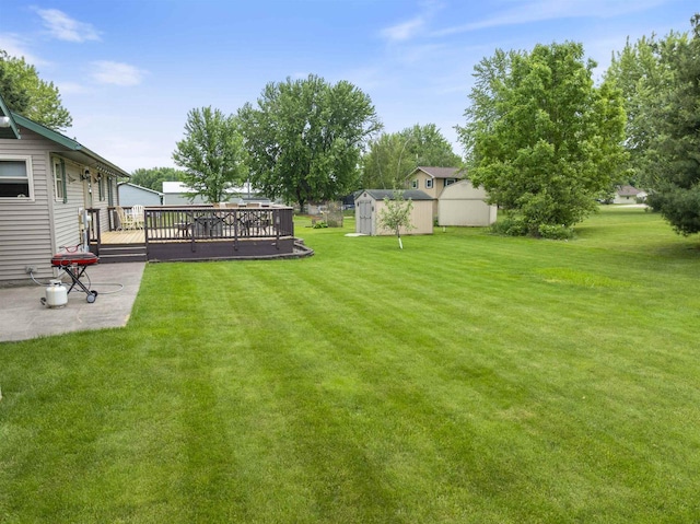 201 N 6th St, Colby, WI 54421 - view of green lawn with a storage shed, a wooden deck, and a patio area