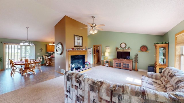 201 N 6th St, Colby, WI 54421 - carpeted living area featuring vaulted ceiling, ceiling fan, a chandelier, and a glass covered fireplace