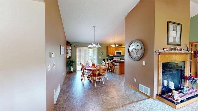201 N 6th St, Colby, WI 54421 - dining room featuring a chandelier, a high end fireplace, and lofted ceiling