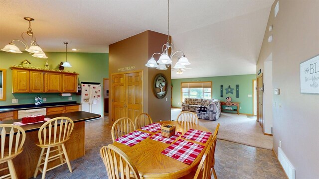 201 N 6th St, Colby, WI 54421 - dining area featuring a chandelier, stone finish floors, and high vaulted ceiling