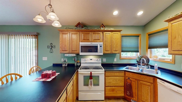 201 N 6th St, Colby, WI 54421 - kitchen with white appliances, dark countertops, pendant lighting, recessed lighting, and brown cabinetry