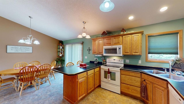 201 N 6th St, Colby, WI 54421 - kitchen with white appliances, a peninsula, a chandelier, lofted ceiling, and dark countertops