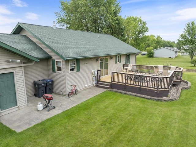 201 N 6th St, Colby, WI 54421 - back of property with a shingled roof, a lawn, a patio, and a wooden deck