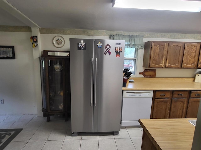 9317 N Arrowhead Shores Rd, Edgerton, WI 53534 - kitchen featuring freestanding refrigerator, white dishwasher, light countertops, and light tile patterned flooring